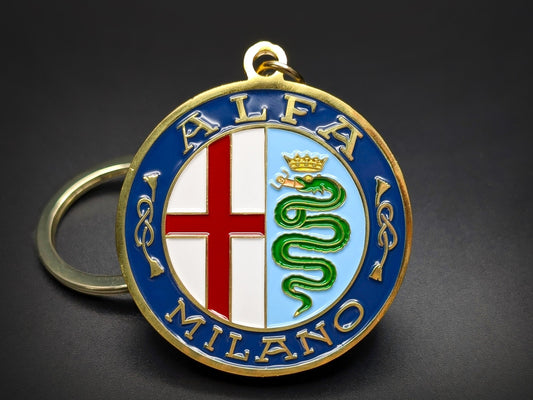 Round gold-trimmed Alfa Romeo vintage metal keychain with a blue border, featuring the red cross of Milan and a green Biscione serpent.