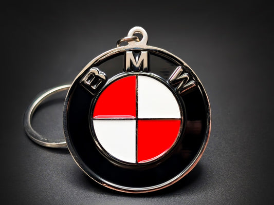 Round black and silver BMW double-sided metal keychain with a red and white checkered logo and "BMW" text.