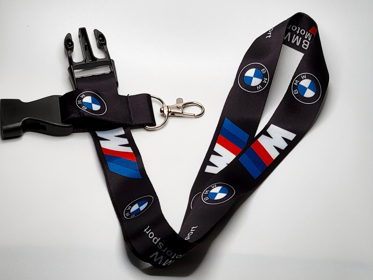 Full layout of a BMW M series lanyard featuring a quick-release buckle, durable silver key attachment, and multi-logo racing design.
