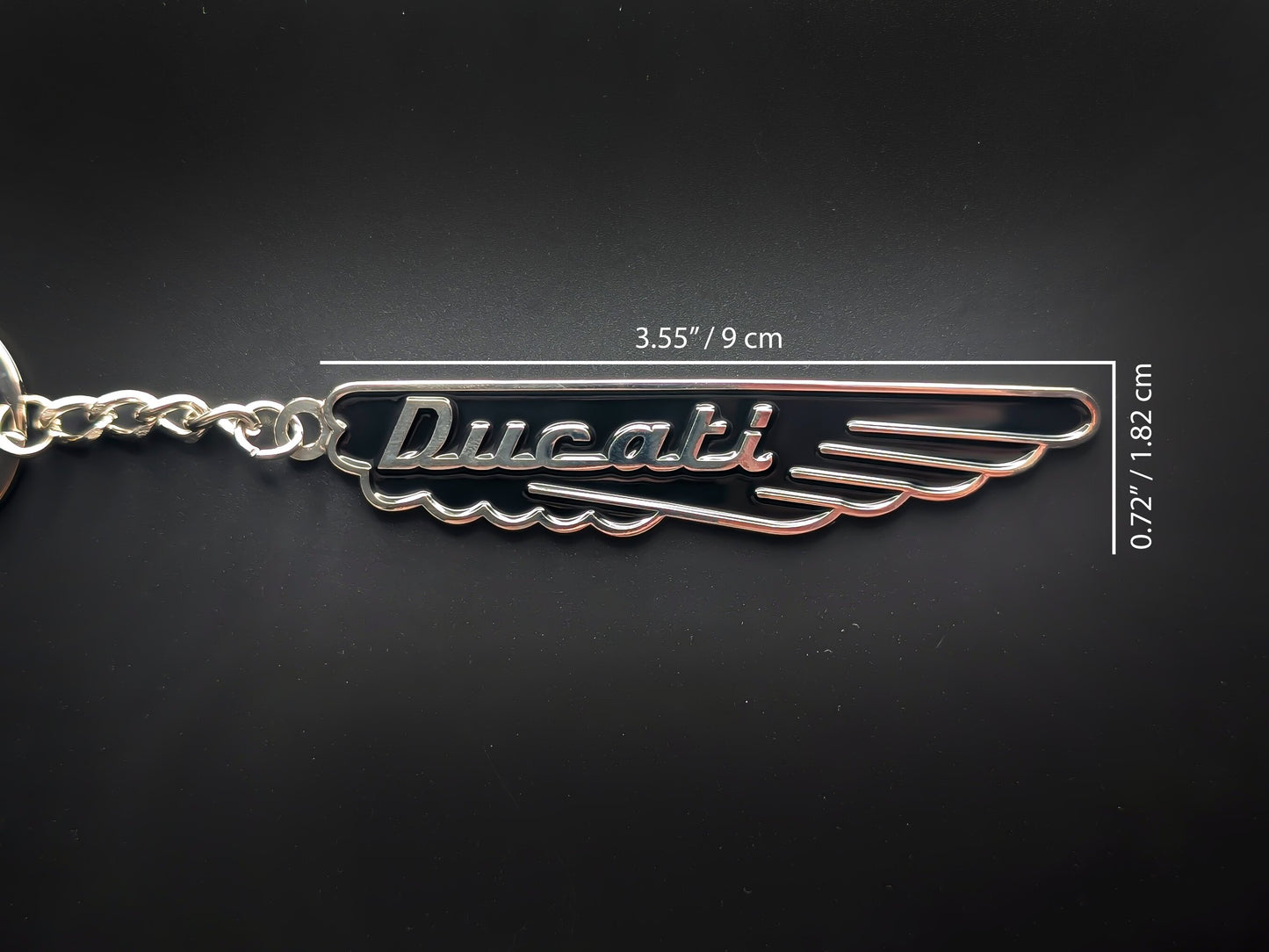 Midnight black Ducati keychain showing dimensions: 3.55 inches (9 cm) long by 0.72 inches (1.82 cm) high.