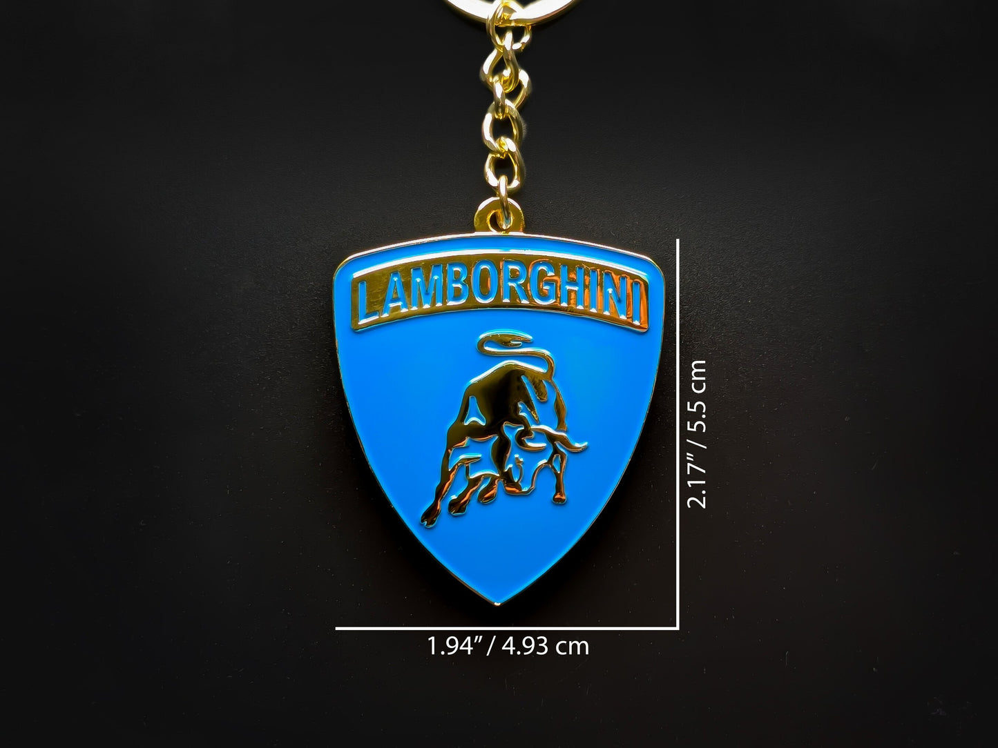 Dimension shot of the Lamborghini blue badge keychain showing a size of 2.17 inches by 1.94 inches (5.5 cm by 4.93 cm).