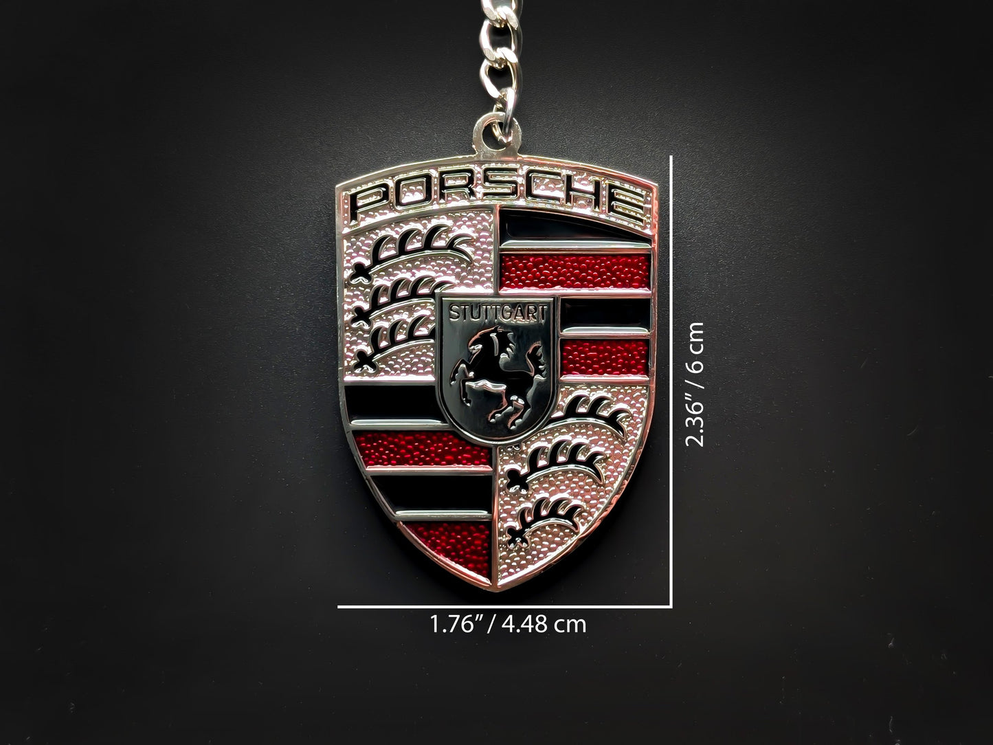 Dimensions of the Porsche red badge keychain showing a size of 2.36 inches by 1.76 inches (6 cm by 4.48 cm).