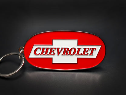 Oval red and silver Chevrolet double-sided metal keychain with the white bowtie logo and "CHEVROLET" text in red outline.