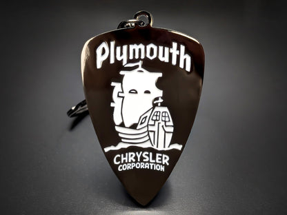Silver Plymouth Chrysler keychain with a dark background and a classic logo featuring the Mayflower ship.