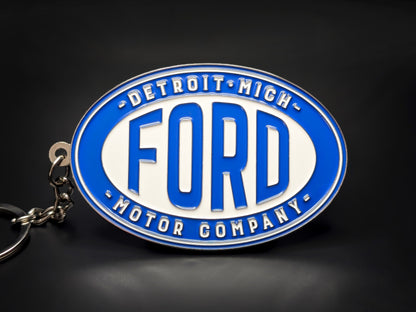 Oval blue and white Ford double-sided metal keychain with "DETROIT MICH" and "MOTOR COMPANY" text around the logo.