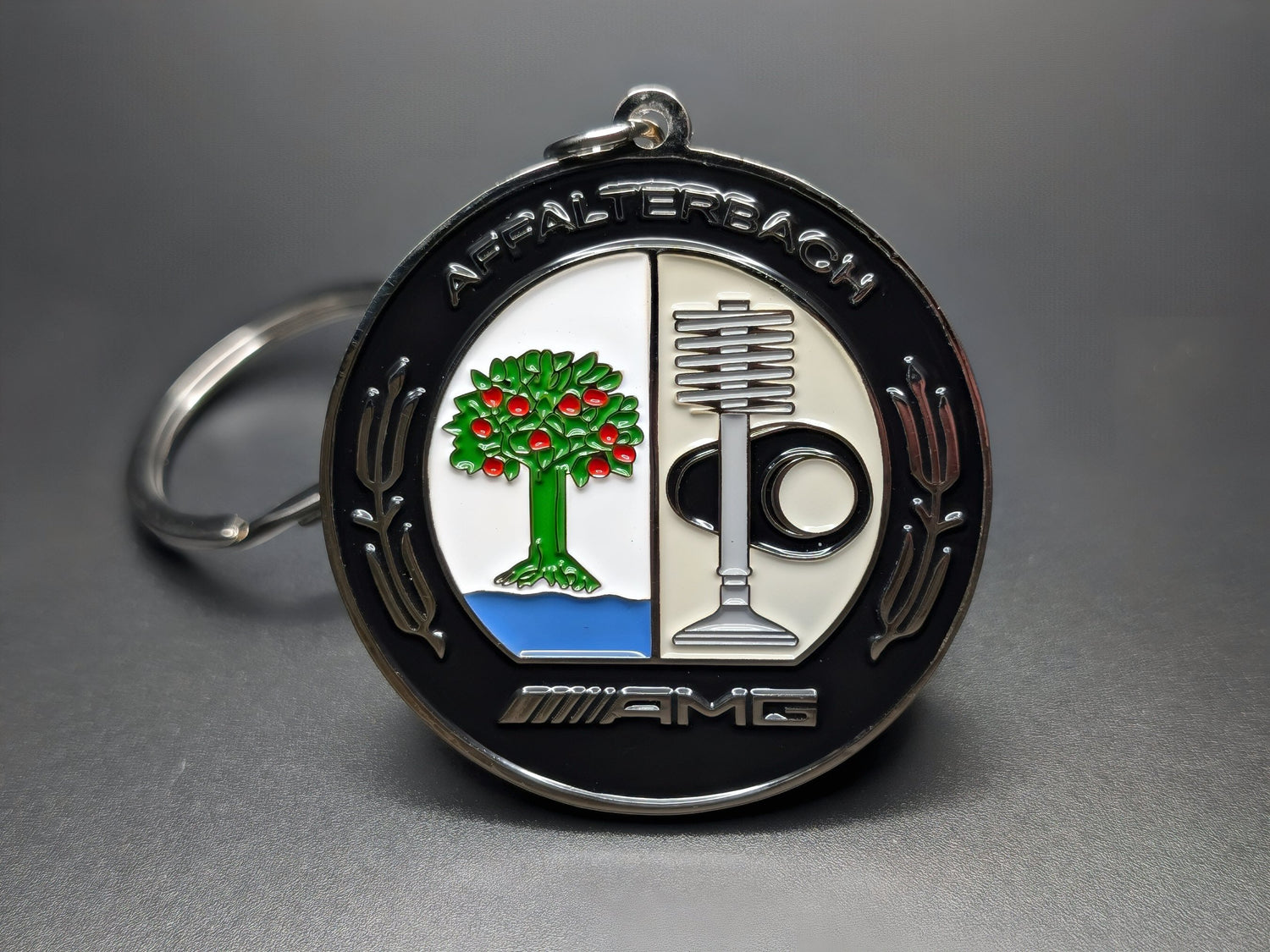 Mercedes-Benz AMG keychain displaying the iconic Affalterbach emblem. Front view.