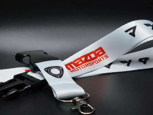 Mazda lanyard featuring the iconic Mazda Motorsports logo, the rotary engine symbol, and the original Mazda logo in Japanese.