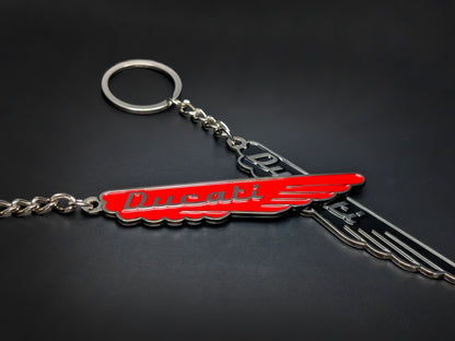 Red and black Ducati wings metal keychain with classic script.