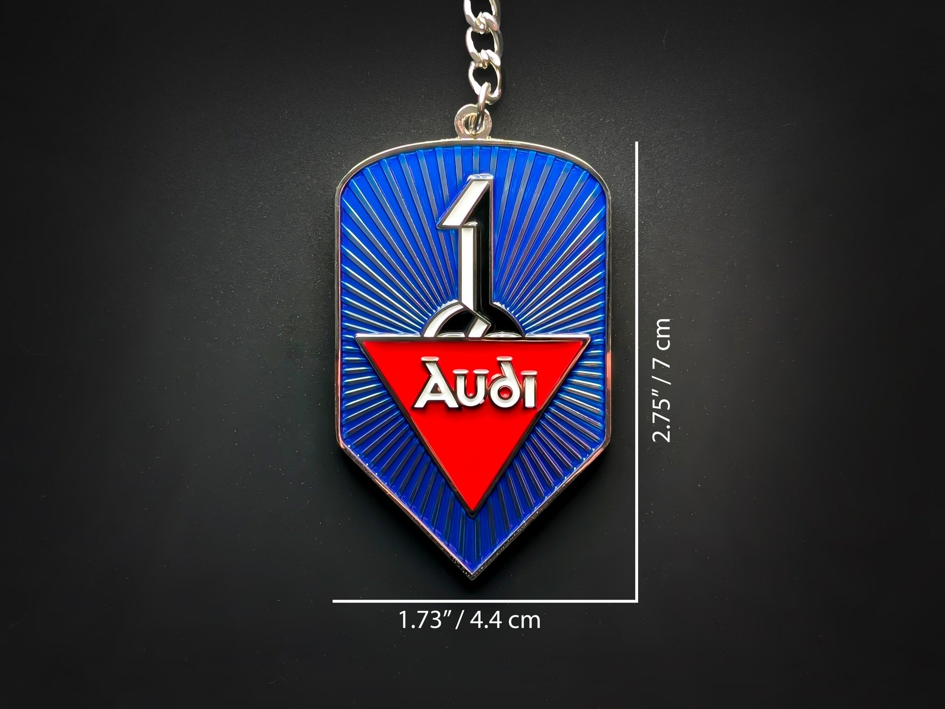 Dimension shot of the Audi badge keychain showing measurements of 2.75 inches by 1.73 inches (7 cm by 4.4 cm).