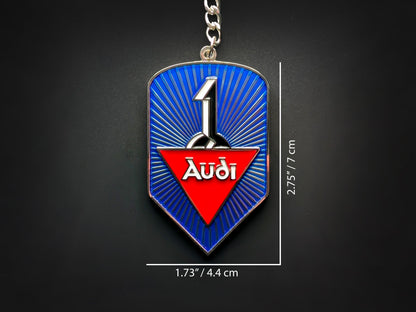 Dimension shot of the Audi badge keychain showing measurements of 2.75 inches by 1.73 inches (7 cm by 4.4 cm).
