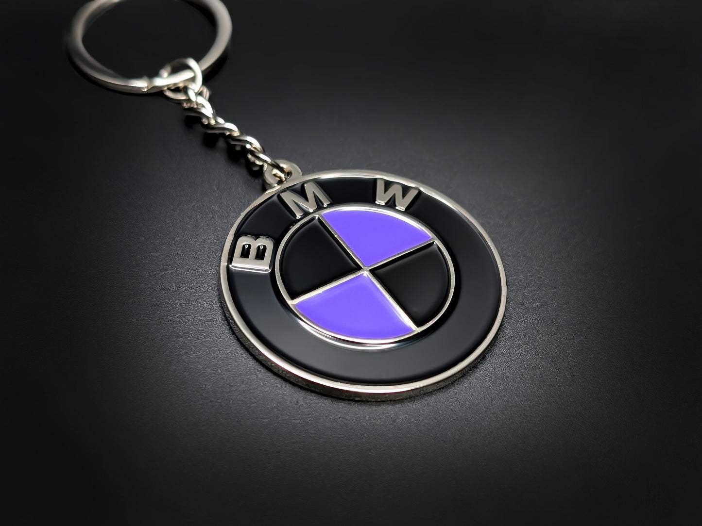 High-quality BMW purple heritage roundel keychain on a dark background, showing the glossy finish and sturdy silver link chain.