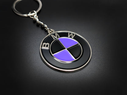High-quality BMW purple heritage roundel keychain on a dark background, showing the glossy finish and sturdy silver link chain.