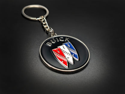 High-quality Buick car badge keychain on a dark background, showcasing the glossy enamel finish and sturdy silver link chain.
