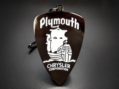 Vintage Chrysler Plymouth badge keychain with the white Mayflower ship logo and "Chrysler Corporation" text on a black shield.