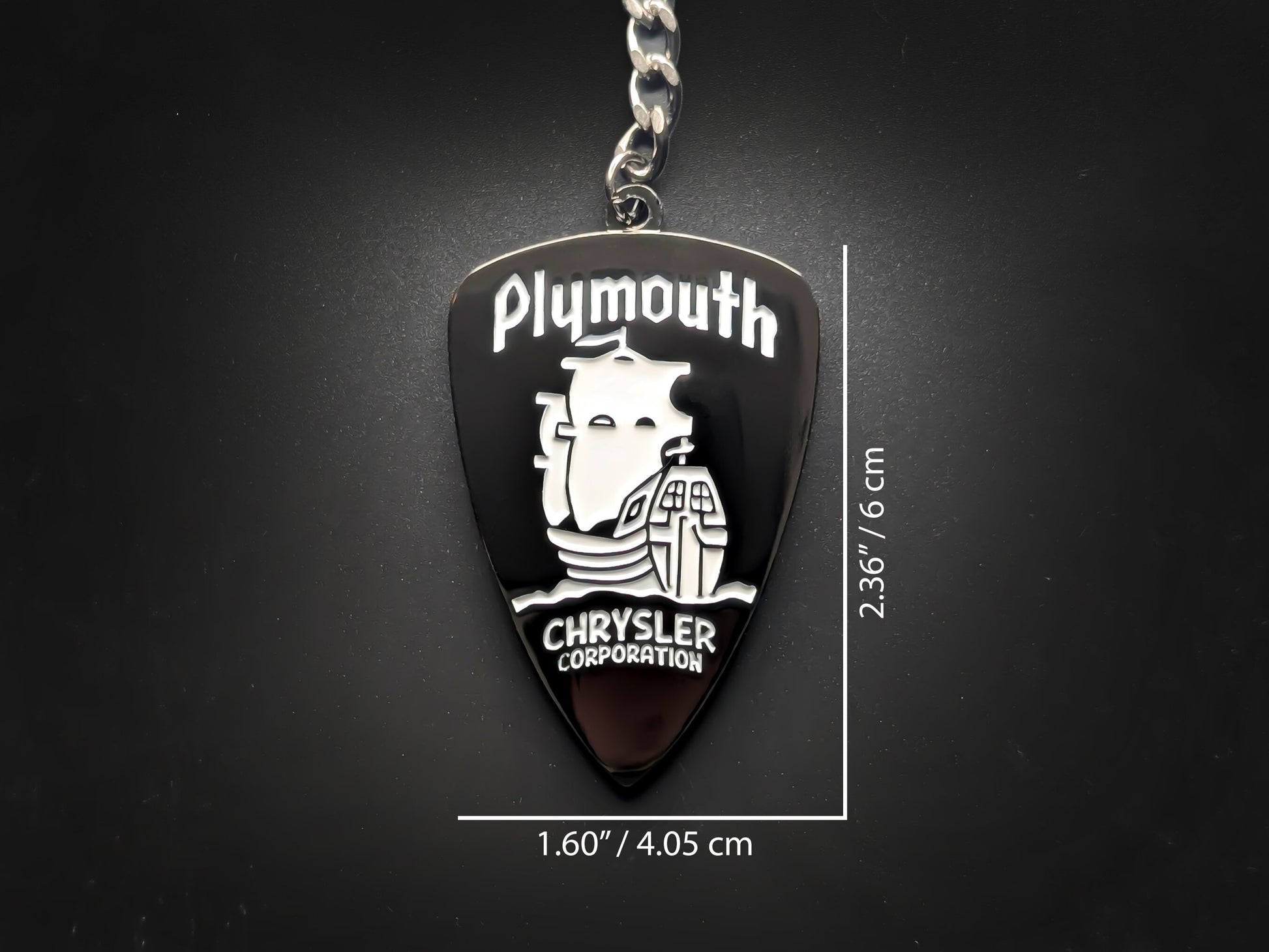 Dimensions of the Chrysler Plymouth badge keychain showing a size of 2.36 inches by 1.60 inches (6 cm by 4.05 cm).