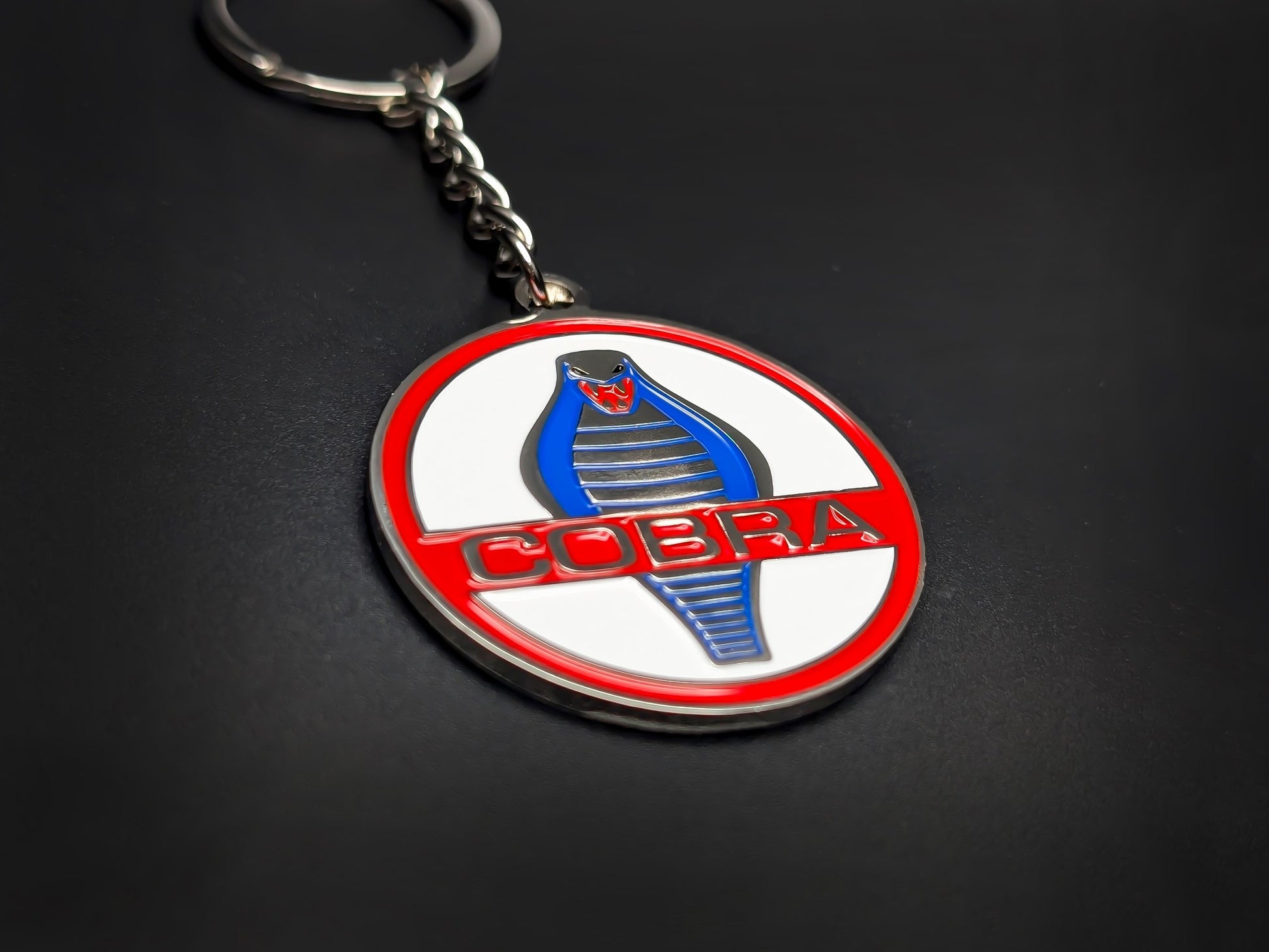 High-quality Shelby Cobra racing keychain on a dark background, showing the polished silver-tone metal and chain.