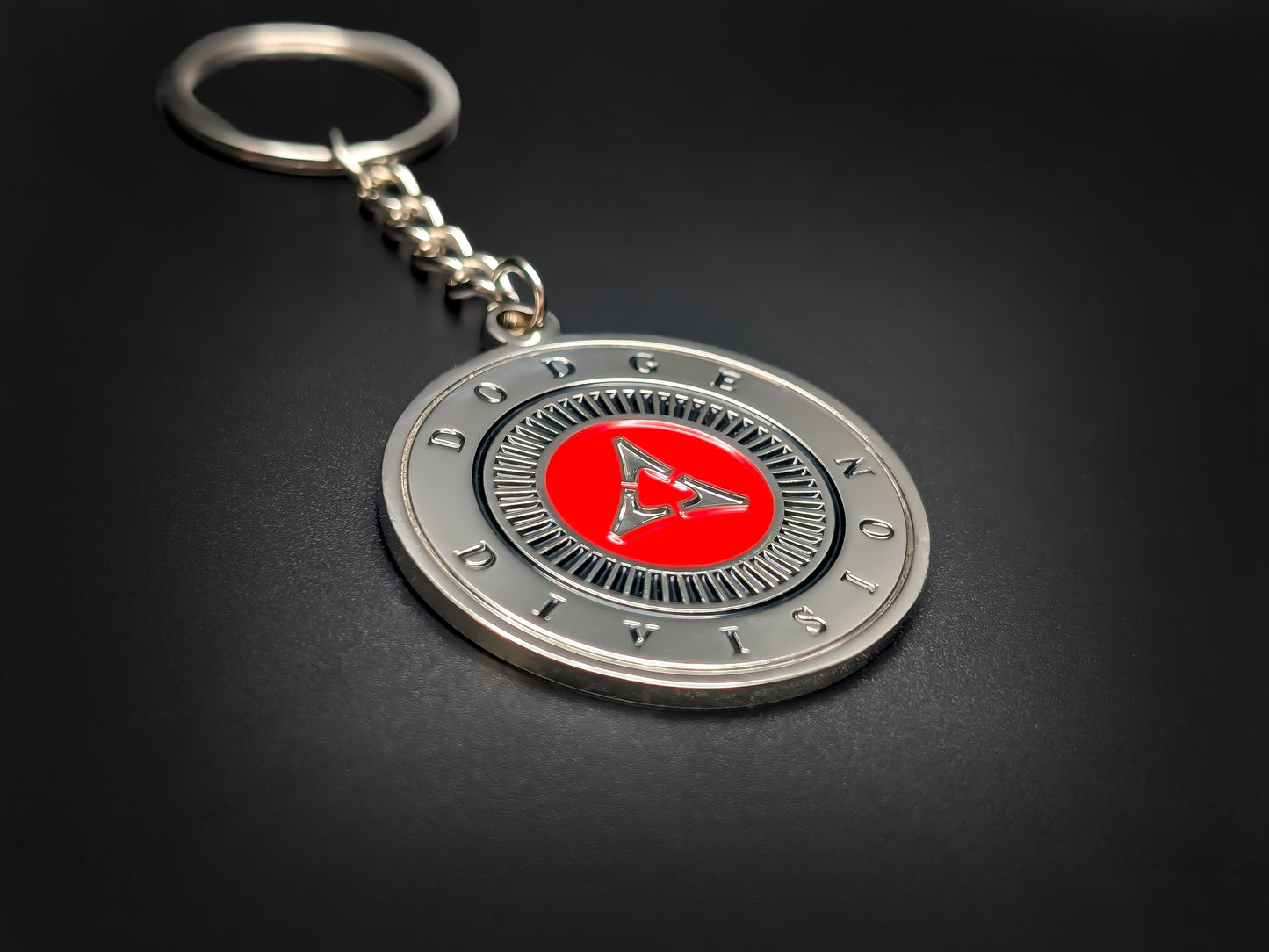 High-quality Dodge Fratzog heritage keychain on a dark background, showcasing the textured silver rays and durable metal chain.