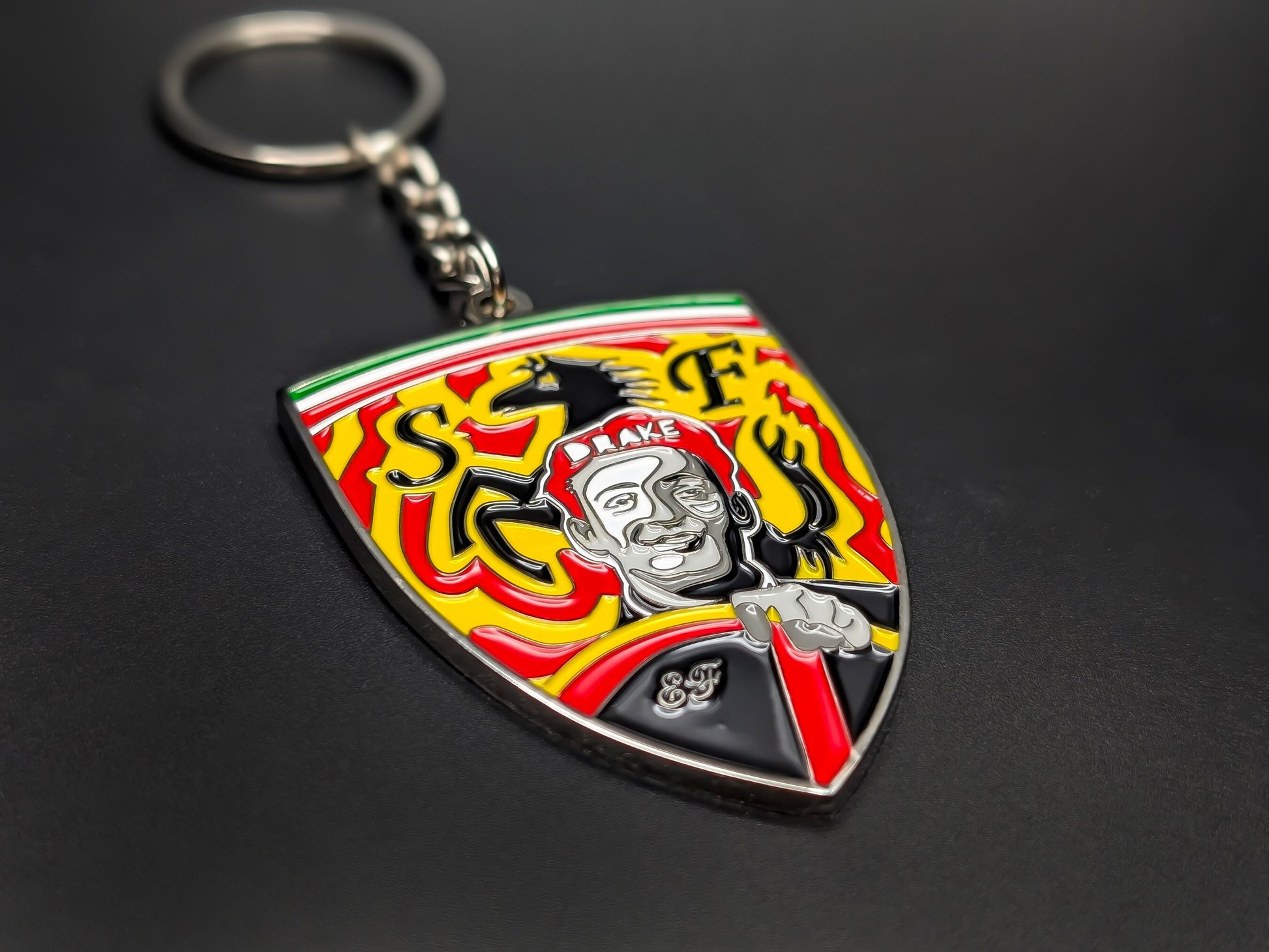 High-quality Enzo Ferrari tribute keychain on a dark background, showing the polished silver-tone trim and Italian tricolor top detail.