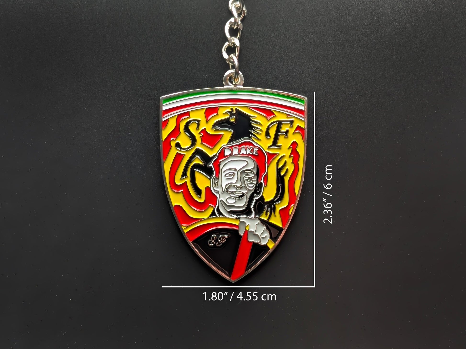 Dimensions of the Enzo Ferrari tribute badge keychain showing a size of 2.36 inches by 1.80 inches (6 cm by 4.55 cm).
