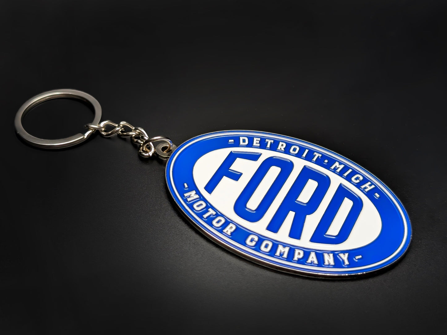 High-quality retro Ford Detroit badge keychain on a dark background, showcasing the glossy enamel finish and silver-tone chain.
