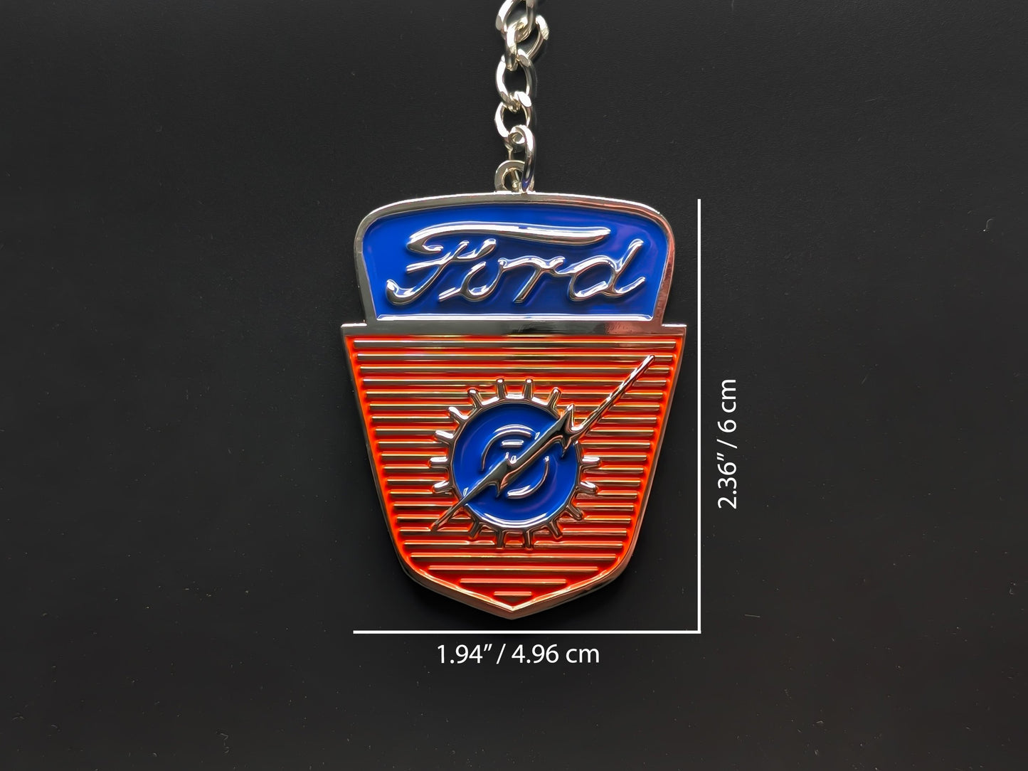 Dimension shot of the Ford vintage truck badge keychain showing a size of 2.36 inches by 1.94 inches (6 cm by 4.96 cm).
