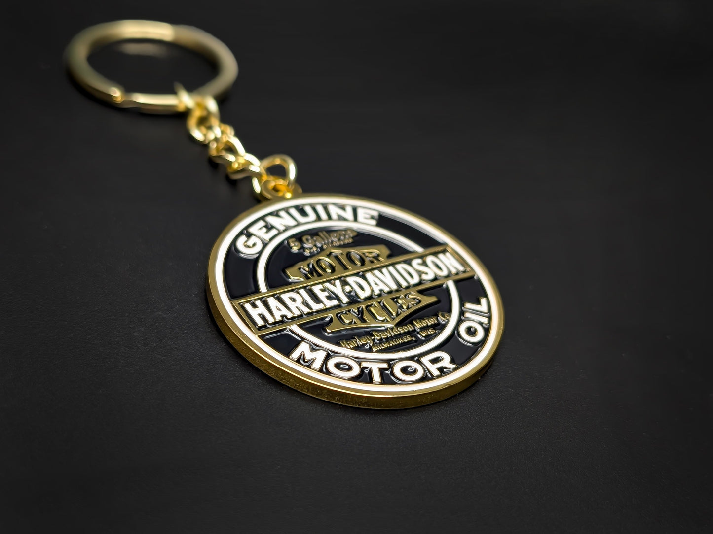 High-quality Harley-Davidson heritage keychain on a dark background, showcasing the polished gold-tone metal and sturdy linked chain.