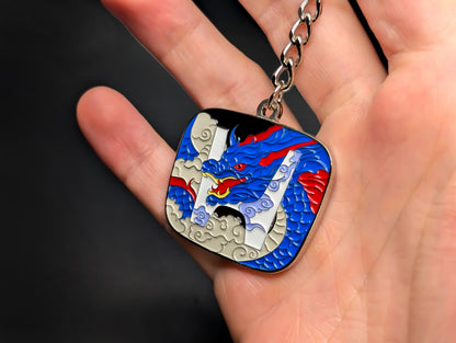 A hand holding the Honda JDM badge keychain, showing the scale and vibrant enamel colors of the dragon design.