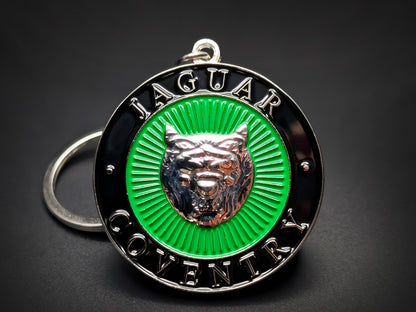 Vintage Jaguar badge keychain featuring a silver Growler logo on a green sunburst enamel center with "Jaguar Coventry" text.
