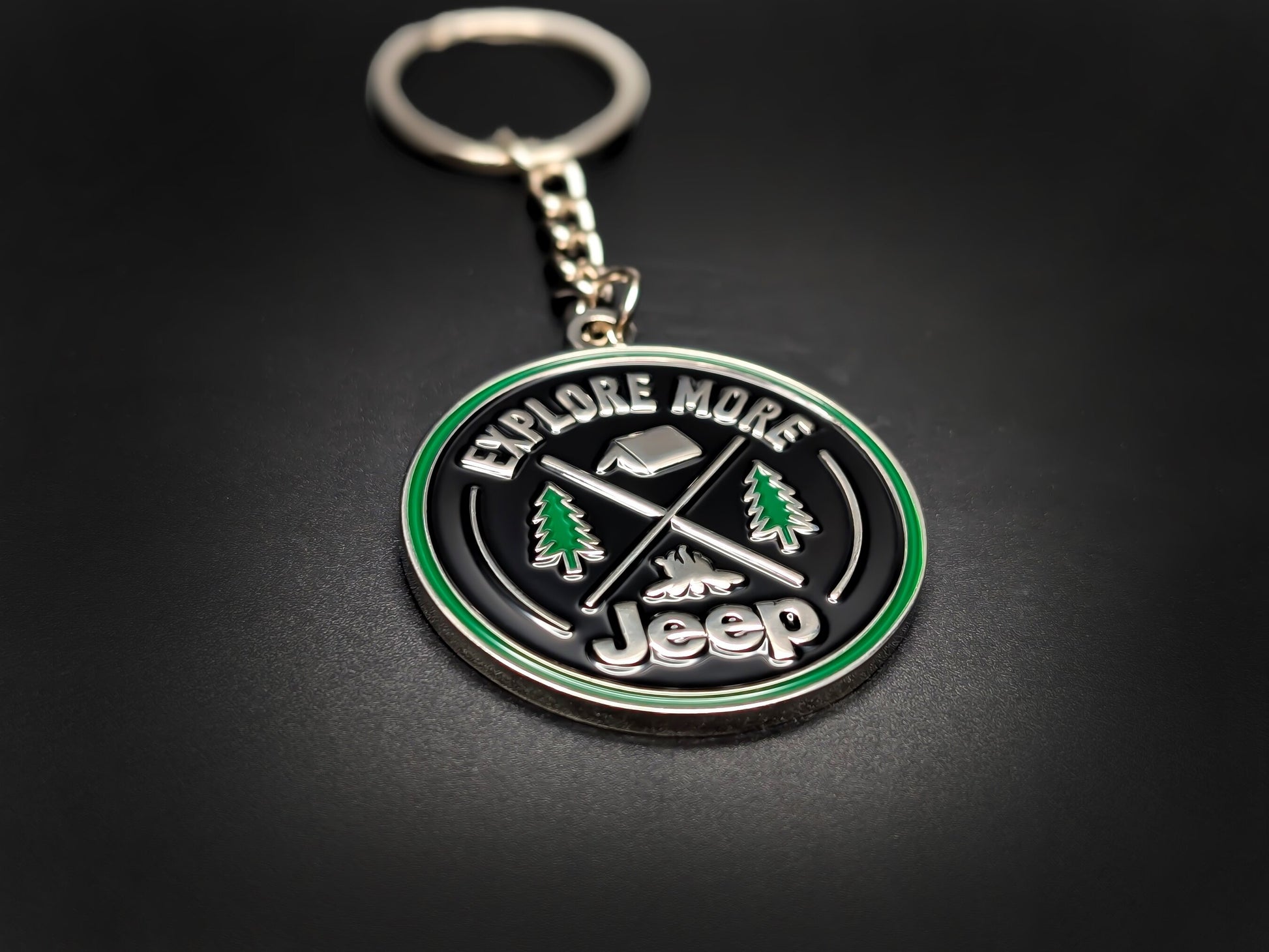 High-quality Jeep adventure keychain on a dark surface, showcasing the polished silver-tone metal and durable linked chain.
