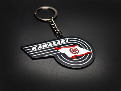 High-quality Kawasaki retro motorcycle badge keychain on a dark background, showing the polished gunmetal chain and ring.