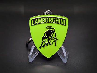 High-gloss green Lamborghini badge keychain on a dark background, showing the polished metallic rim and chain.