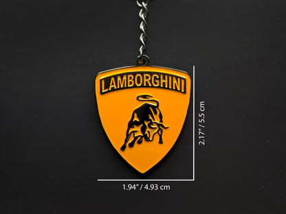 Dimension shot of the Lamborghini orange badge keychain showing a size of 2.17 inches by 1.94 inches (5.5 cm by 4.93 cm).