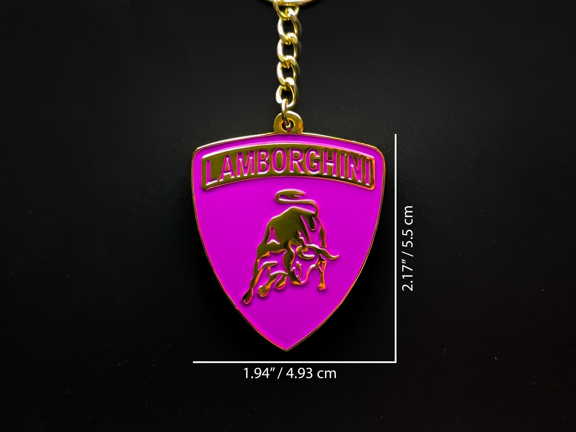 Dimension shot of the Lamborghini purple badge keychain showing a size of 2.17 inches by 1.94 inches (5.5 cm by 4.93 cm).