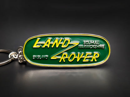 Vintage Land Rover badge keychain in green and yellow enamel, featuring Solihull, Warwickshire and England text.