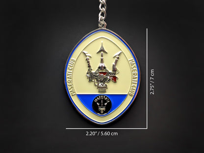 Product dimension shot of the Maserati badge keychain showing it measures 2.75 inches by 2.20 inches (7 cm by 5.60 cm).
