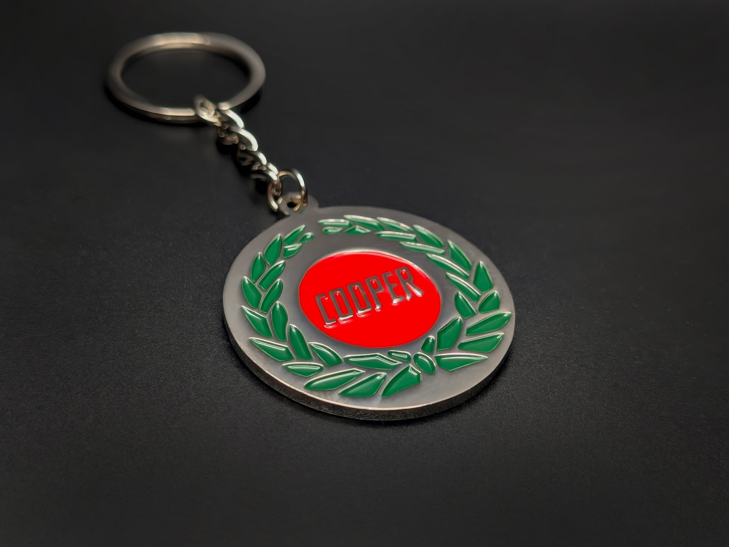 High-quality Mini Cooper heritage keychain on a dark background, showcasing the glossy enamel finish and sturdy silver link chain.