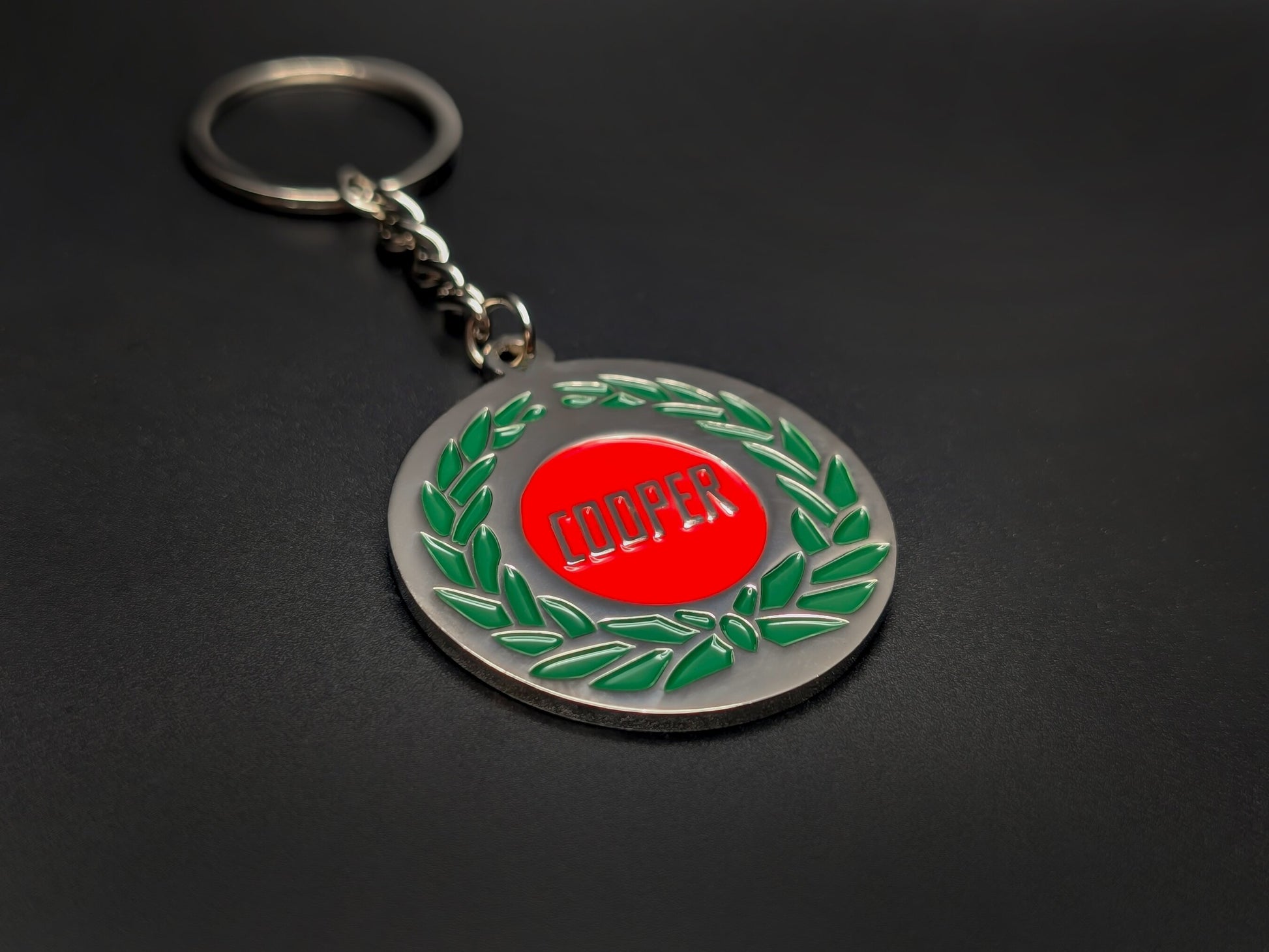 High-quality Mini Cooper heritage keychain on a dark background, showcasing the glossy enamel finish and sturdy silver link chain.
