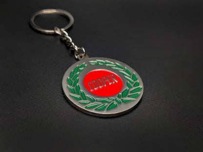 High-quality Mini Cooper heritage keychain on a dark background, showcasing the glossy enamel finish and sturdy silver link chain.