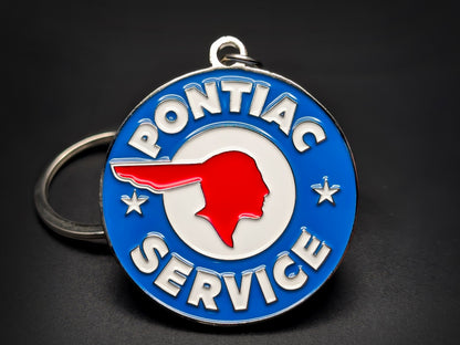 Vintage Pontiac Service badge keychain featuring a red silhouette on white and blue circular enamel with silver-tone lettering.