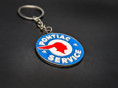 High-quality Pontiac heritage keychain on a dark background, showing the polished metallic rim and durable linked chain.