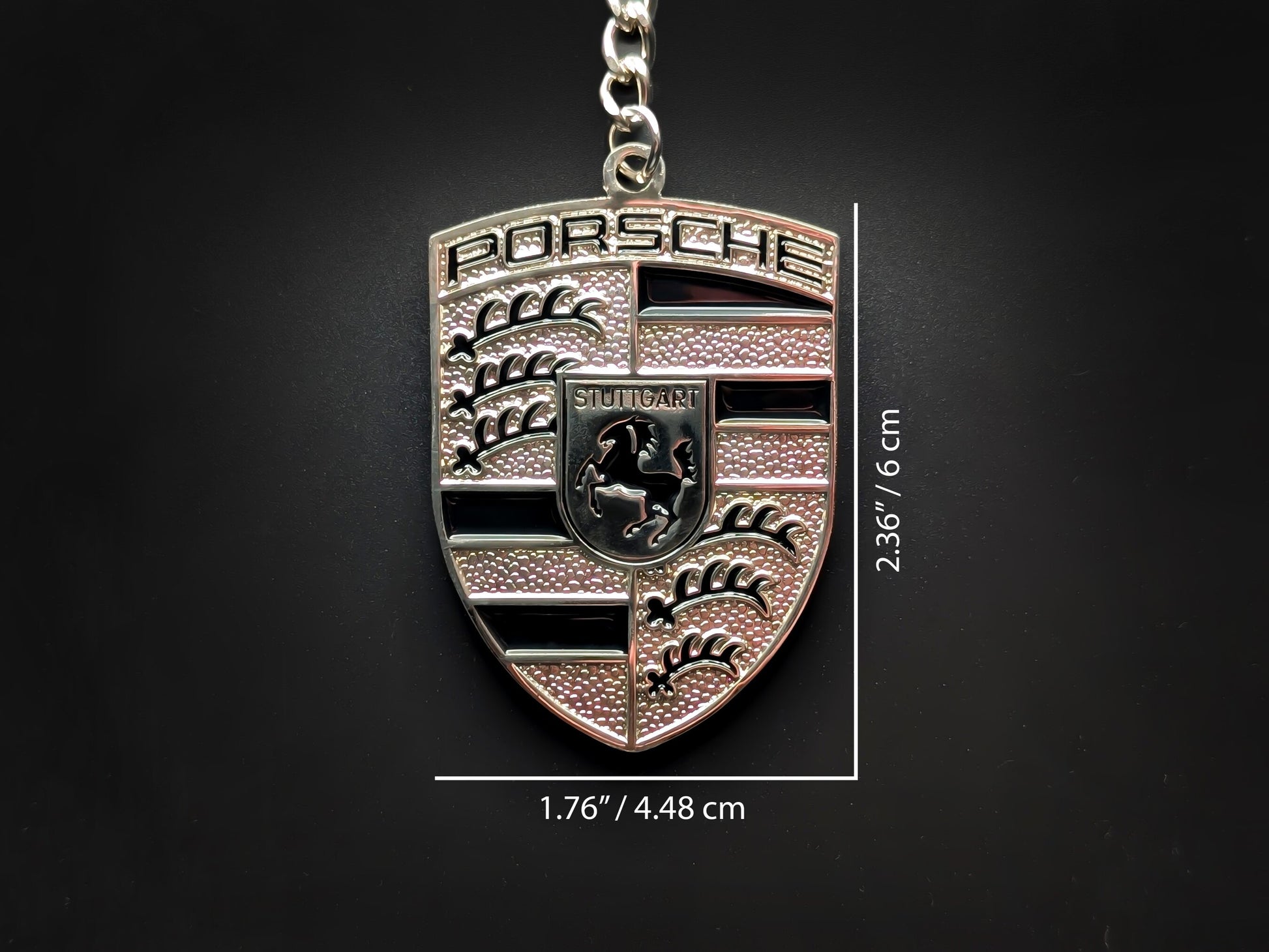 Dimensions of the Porsche black badge keychain showing a size of 2.36 inches by 1.76 inches (6 cm by 4.48 cm).