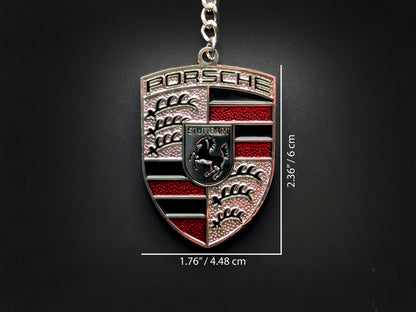 Dimensions of the Porsche red badge keychain showing a size of 2.36 inches by 1.76 inches (6 cm by 4.48 cm).