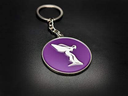 High-gloss purple Rolls-Royce Spirit of Ecstasy badge keychain on a dark surface, showing the polished silver chain and ring.
