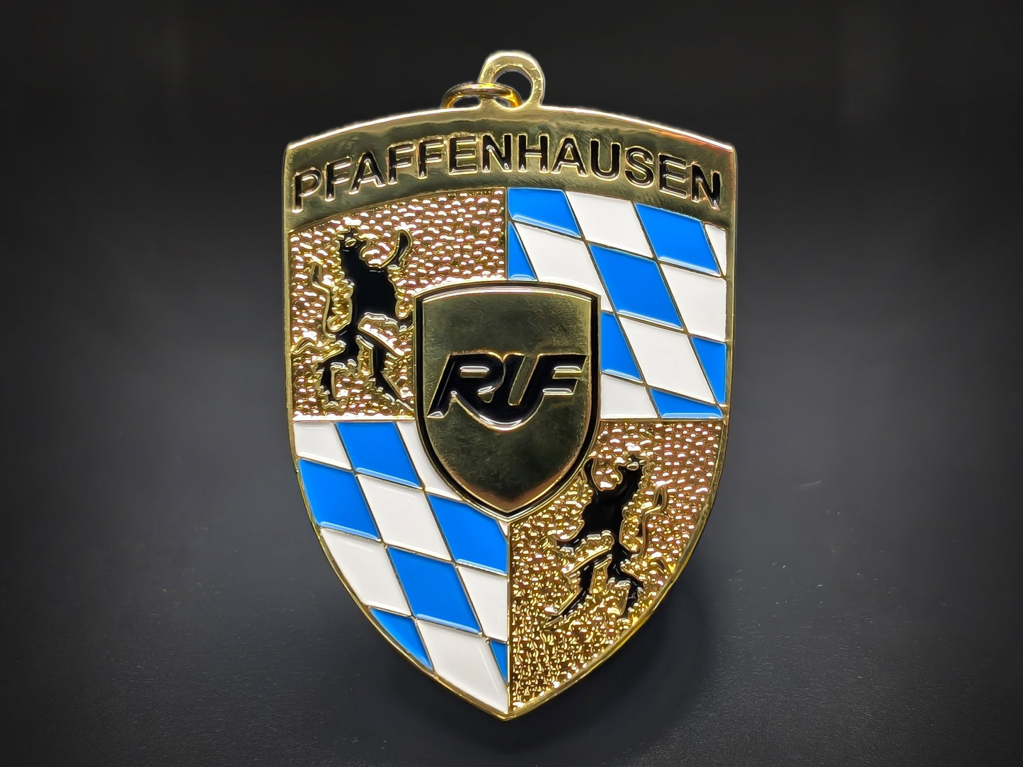 RUF Automobile badge keychain featuring the Pfaffenhausen text, Bavarian blue checkers, and gold-plated textured crest.