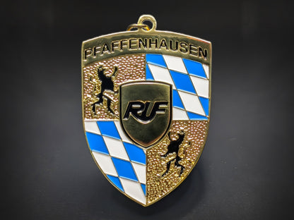 RUF Automobile badge keychain featuring the Pfaffenhausen text, Bavarian blue checkers, and gold-plated textured crest.