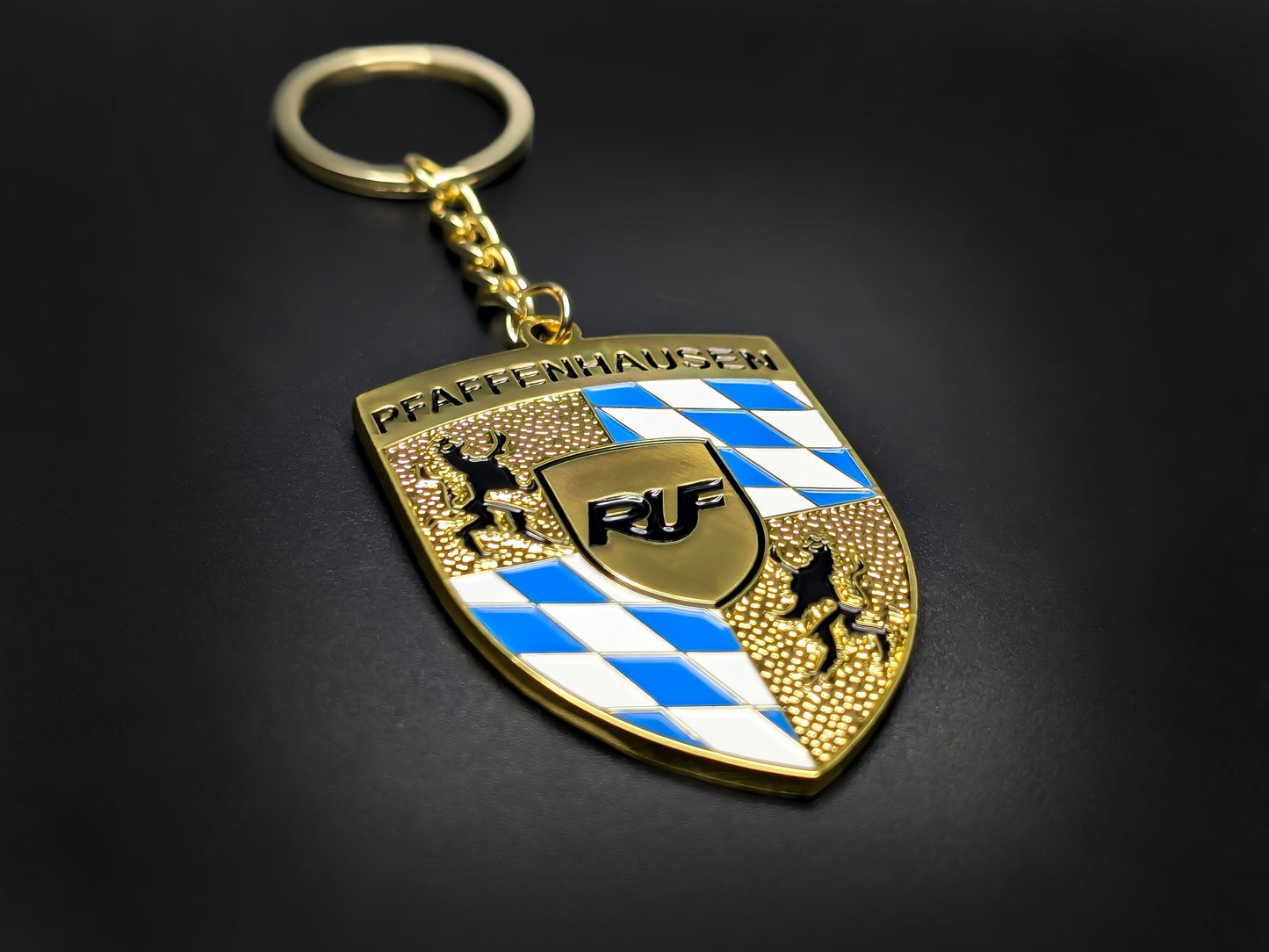 High-quality RUF Porsche badge keychain on a dark background, showcasing the polished gold finish and heavy-duty metal chain.