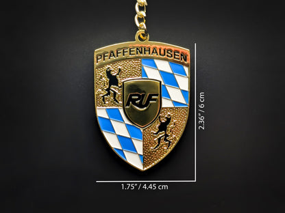 Dimension shot of the RUF badge keychain showing a size of 2.36 inches by 1.75 inches (6 cm by 4.45 cm).