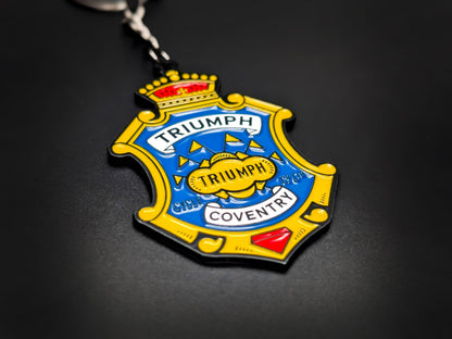 High-quality Triumph motorcycle heritage badge keychain on a dark background, showing the polished enamel and metal detail.