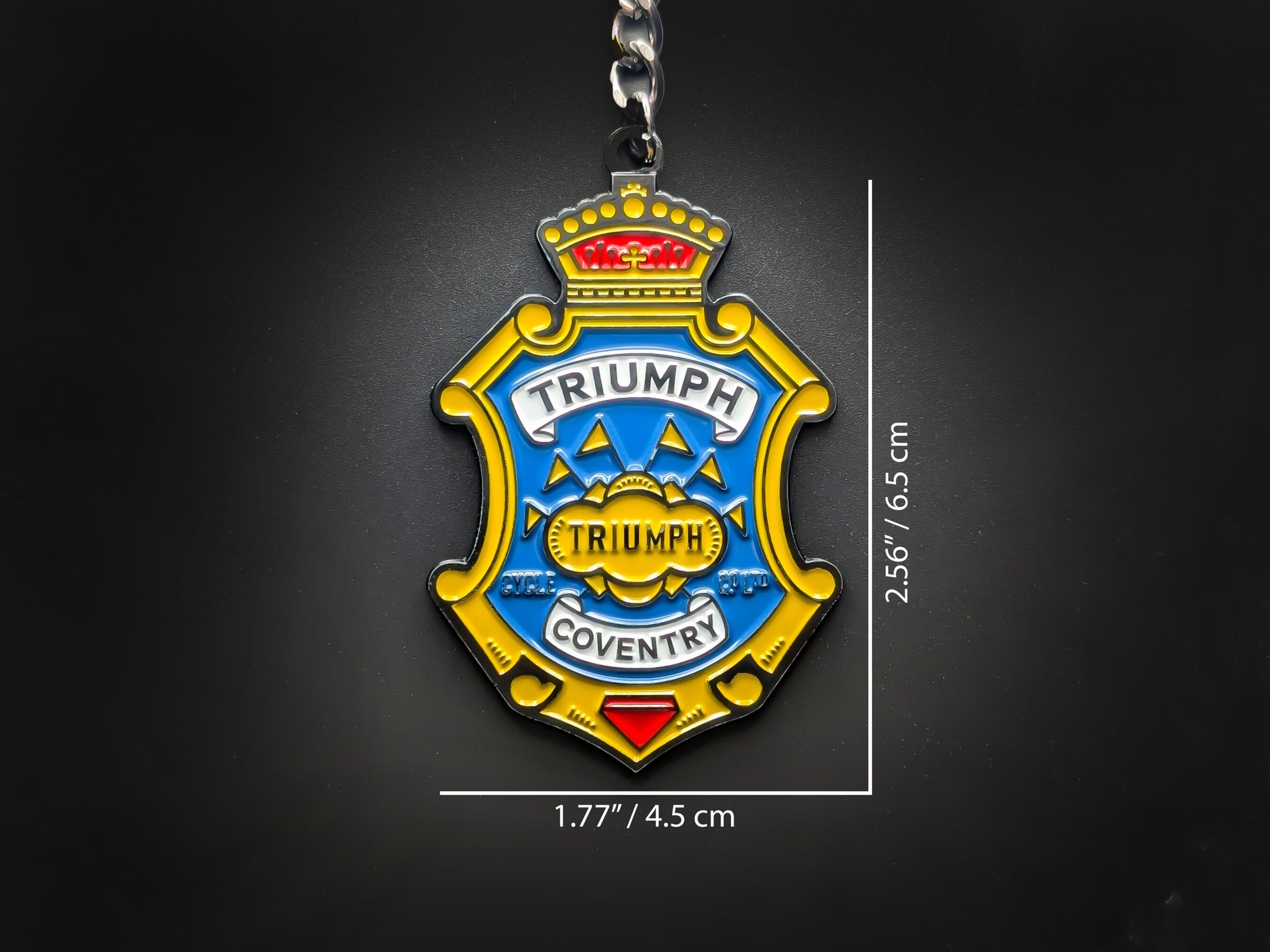 Dimensions of the Triumph badge keychain showing a size of 2.56 inches by 1.77 inches (6.5 cm by 4.5 cm).