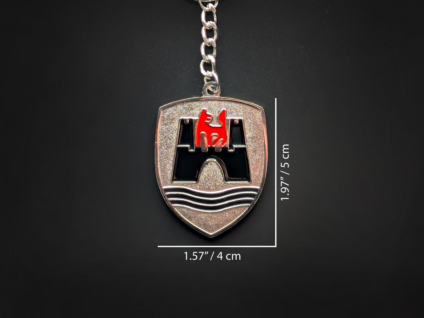 Dimensions of the VW Wolfsburg badge keychain showing a size of 1.97 inches by 1.57 inches (5 cm by 4 cm).